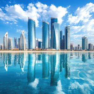 stunning Abu Dhabi skyline features modern skyscrapers reflecting beautifully in calm waters, showcasing vibrant cityscape under bright blue sky